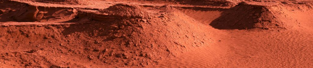Experience the vast beauty and striking patterns of desert dunes under a warm sunset glow.